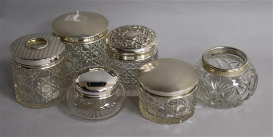 Six assorted silver mounted toilet jars.